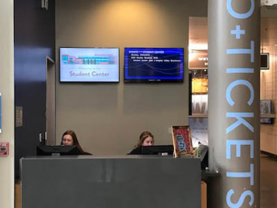 Student at info and ticket desk in sc