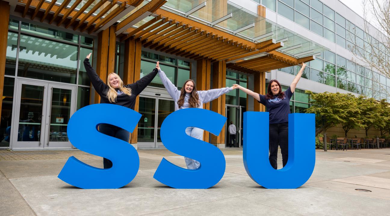 Students celebrating next to the SSU letters
