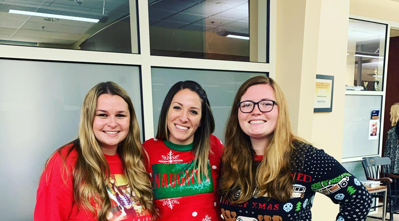 staff in holiday sweaters