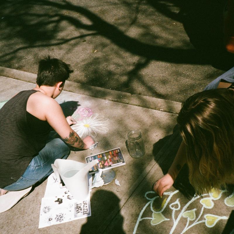 student chalking the ground