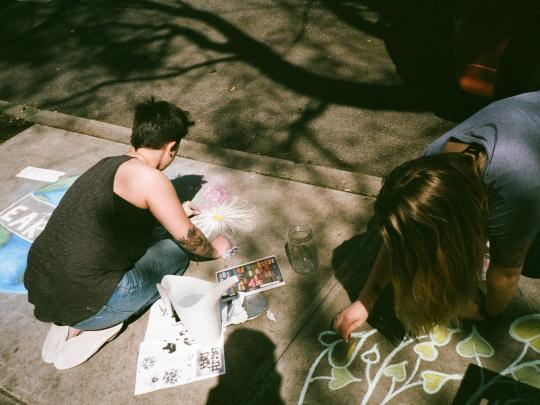 student chalking the ground