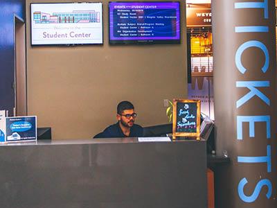student at info and tickets desk