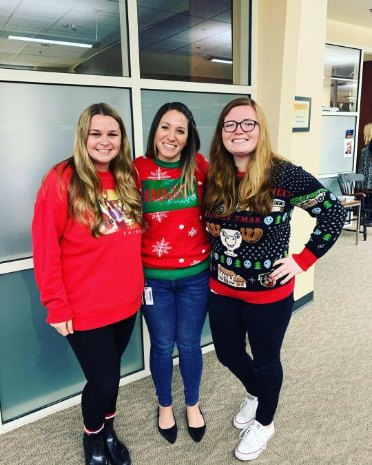 staff in holiday sweaters